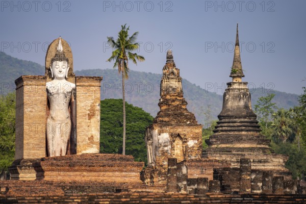 Giant standing Buddha in the Wat Mahathat temple in the UNESCO World Heritage Sukhothai Historical