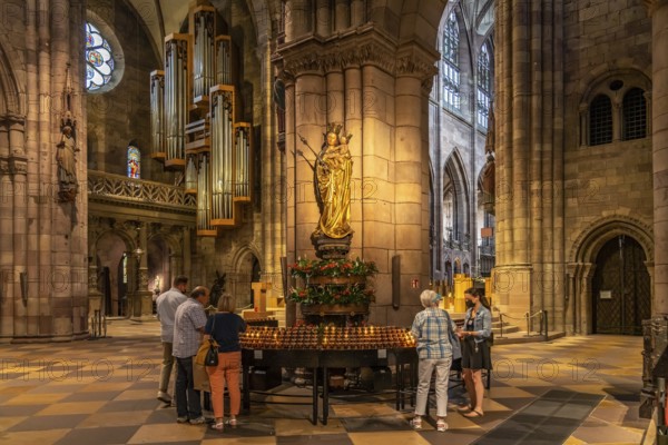 Madonna and sacrificial candles in the interior of Freiburg Minster, Freiburg im Breisgau, Black
