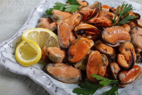 Mussels no shell, boiled, mussels, peeled, in a bowl, with lemon and parsley, Chilean mussels, top