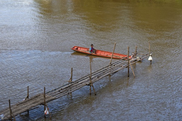 Red boat on a bamboo jetty on the Mekong, Luang Prabang, Laos, Asia