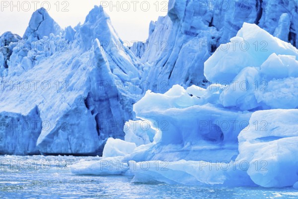 Iceberg by a glacier floating in the sea in Arctic Svalbard, Norway, Europe
