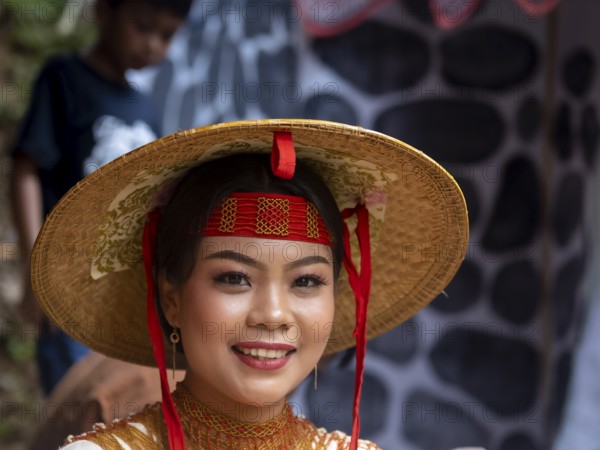 Toraja woman in traditional colourful clothes with rice straw hat, smiling, portrait, Tana Toraja,