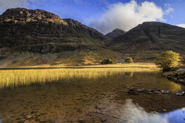 Mountains reflected in loch, evening light, cloudy mood, Achnambeithach Cottage, Loch Achtriochtan,