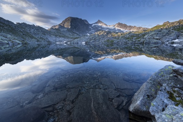 Mountain lake with impressive reflection of the mountains and clouds in the water, Krimml,