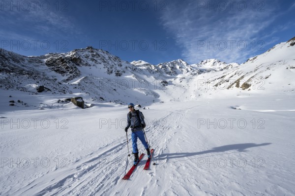 Ski tourers in Val Martello, snow-covered mountain landscape, Monte Cevedale mountain peak in the