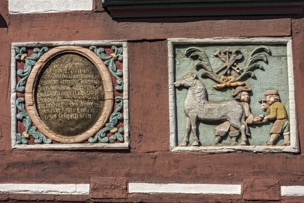 Colourful painted carvings, medallion with inscription, relief for blacksmith Johenrich Jung on the
