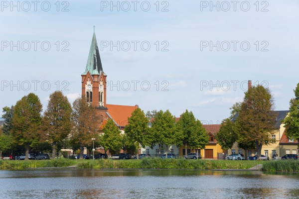 A picture of the church on the riverbank with surrounding buildings and trees, Maria Meeresstern