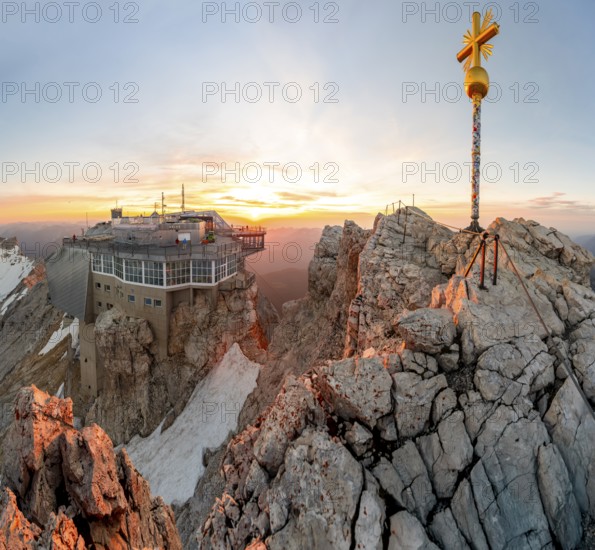 Summit of the Zugspitze with golden summit cross and mountain station of the Bavarian Zugspitze,