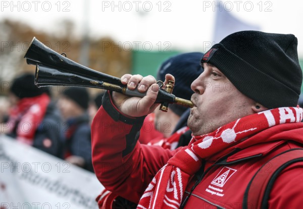 A Volkswagen employee demonstrates with a trumpet in front of the Volkswagen Arena during the