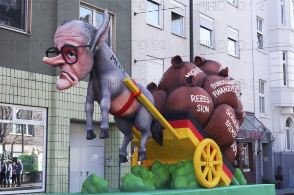 Chancellor candidate Friedrich Merz as a donkey figure in front of a cart with heavy sacks, debt