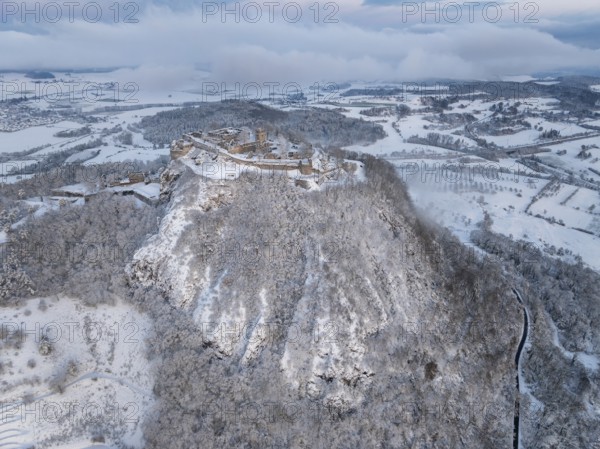 Aerial view of the snow-covered Hegau volcano Hohentwiel with Germany's largest castle ruins on a