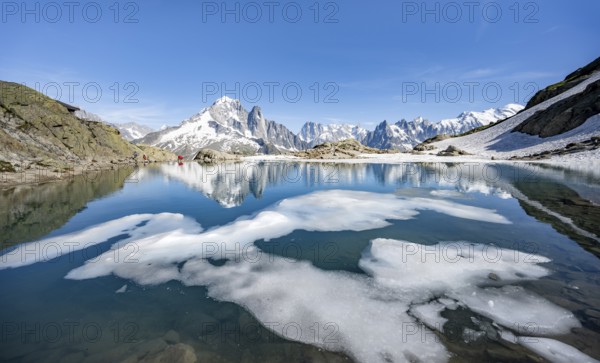 Mountain landscape with mountain lake and ice floe, water reflection in Lac Blanc, mountain peak,
