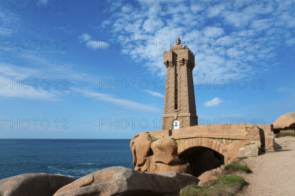 A lighthouse stands over a bridge on the rocky coast, Phare de Men Ruz, Ploumanac'h, Ploumanach,