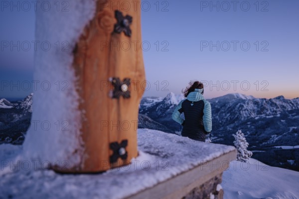 Summit bliss in the snow-covered winter landscape in the Tannheimer Tal in the Alps on the