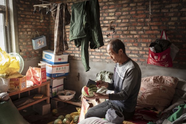 Worker Yang Zhao Bin at his sleeping place, the workers live in the respective buildings where the