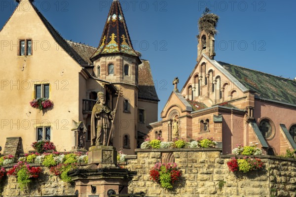 Fountain Fontaine de Saint-Léon and St Leo's Chapel in Eguisheim, Alsace, France, Europe