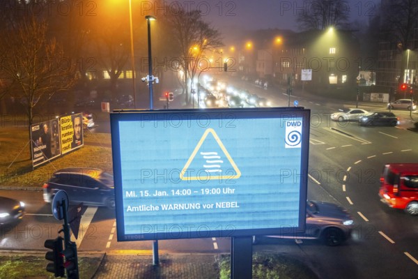 Dense fog, with visibility partly below 100 metres, city centre traffic at rush hour on