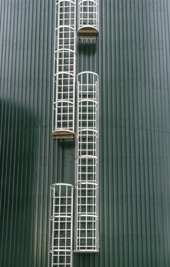 Fixed ladders with back protection on a technical building, climbing protection, silo, offset