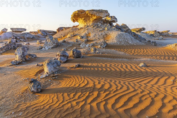 Striking cliffs surrounded by windswept sand structures, Huqf stone desert, Arabian Peninsula,