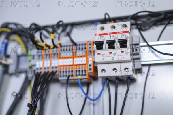 Close-up of circuit-breakers and cables in an electrical system, showing precision in the