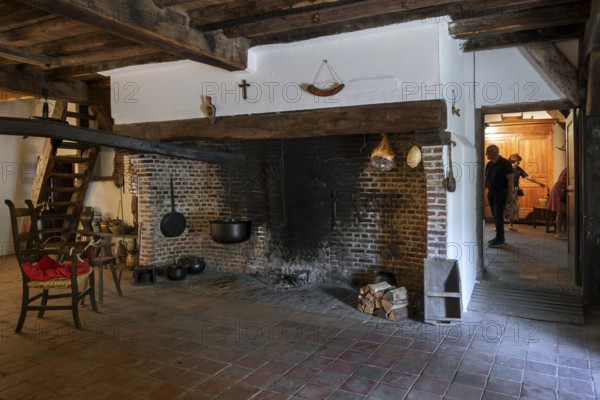Big hearth, open fireplace in kitchen of 18th century farmhouse Uitschoolhoeve Oevel at open air