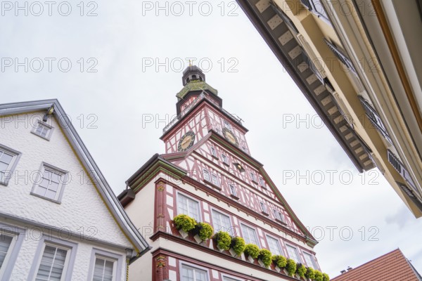 Half-timbered house with soaring church tower and ornate gables, Kirchheim Teck, Germany, Europe