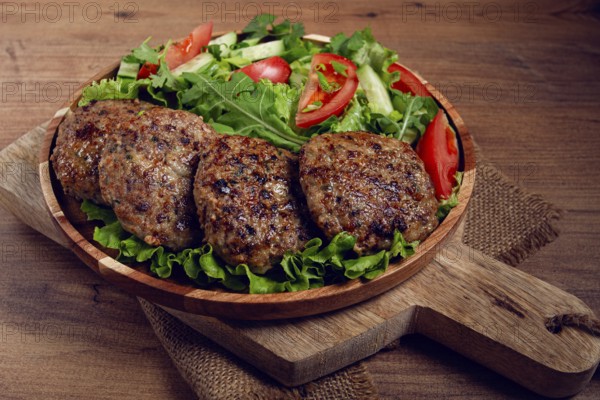 Fried cutlets, mixed minced meat, with vegetable salad, homemade, top view, no people