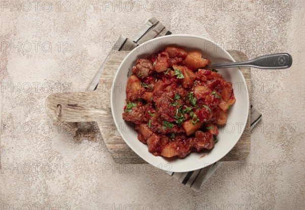 Stew with potatoes and vegetables, in tomato sauce, with spices and herbs, close-up, homemade, no