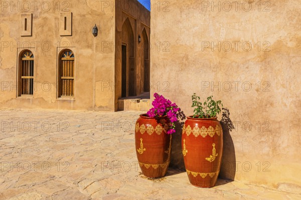 An inner courtyard of the palace fortress of Jabrin, decorated with large flower vases, Jabrin,