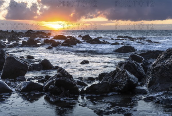 Rocks on the beach of Playa del Inglés. Sunset. Sea and waves. Valle Gran Rey, La Gomera, Canary