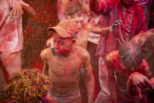 Revellers smear with Gulal or coloured powder and dance to play Holi, the Hindu spring festival of