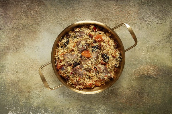 Rice dish with meat and dried fruits, in a large pot, pilaf, homemade, no people