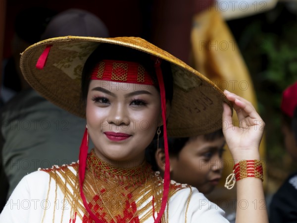 Toraja woman in traditional colourful clothing with rice straw hat, portrait, Tana Toraja,