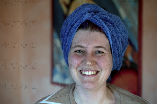Portrait of a laughing young woman, the towel wrapped around her head like a turban, Bavaria,
