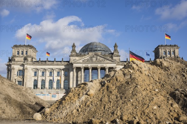 Reichstag building in Berlin Mitte behind Sandbergen due to construction work on the Platz der