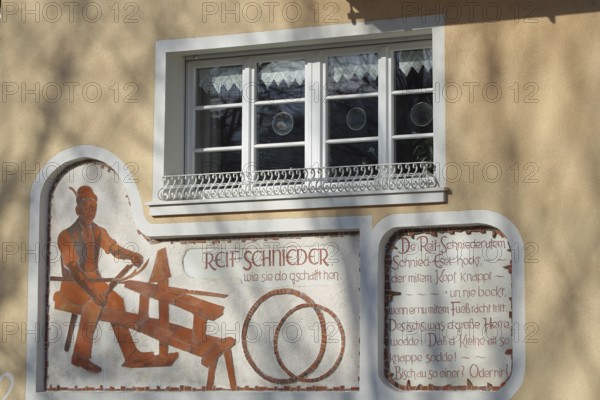 Wall painting with historical tyre cutter and saying in dialect, traditional craft, barrel tyre,