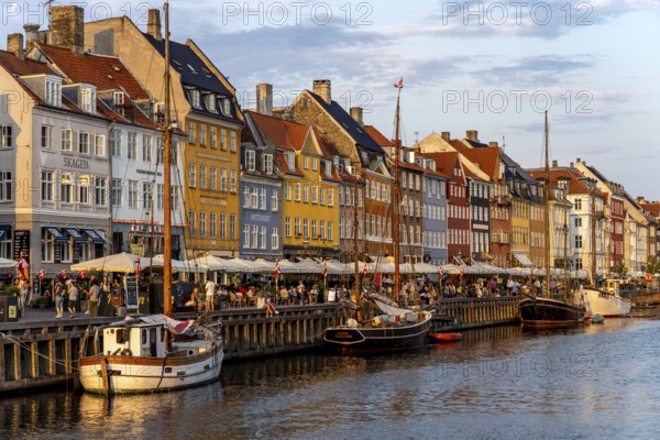 Colourful houses, restaurants and historic ships on the Nyhavn canal and harbour, Copenhagen,