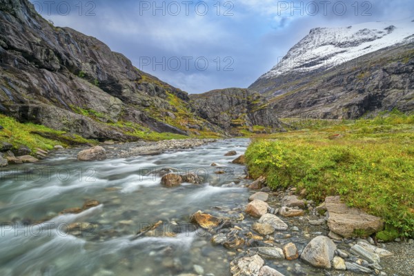 Mountain stream at Trollstigen, snow-covered mountain in the background, Alnestinden, Åndalsnes,