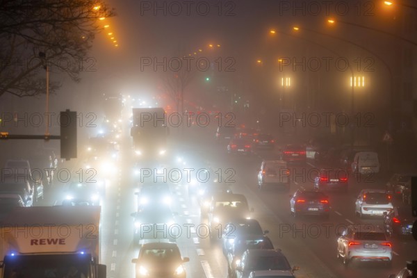 Dense fog, with visibility sometimes less than 100 metres, city centre traffic at rush hour on