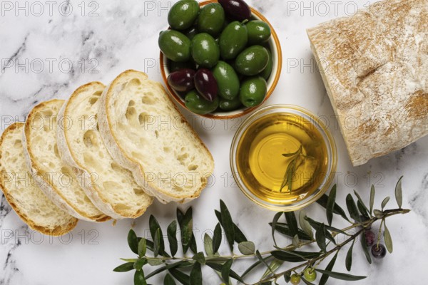 Appetizer, sliced ciabatta bread, with olive oil, green olives, Chalkidiki olives, classic Green