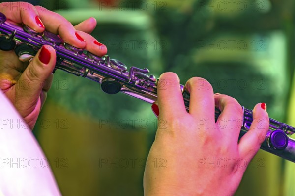 Detail of a woman playing the transverse flute during a musical performance Brazil