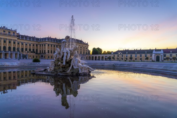 Fountain in the courtyard of honour at Schönbrunn Palace at dusk, UNESCO World Heritage Site in