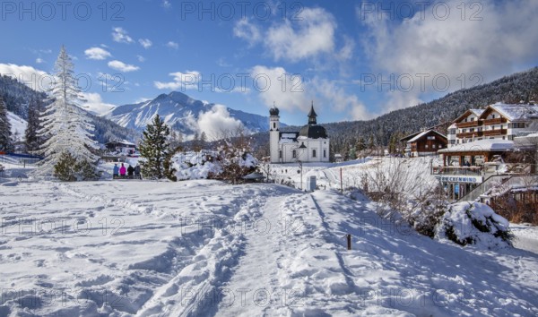 Seekirchl with artificial winter fir tree and Hocheder 2797m in winter, Seefeld, Seefeld Plateau,