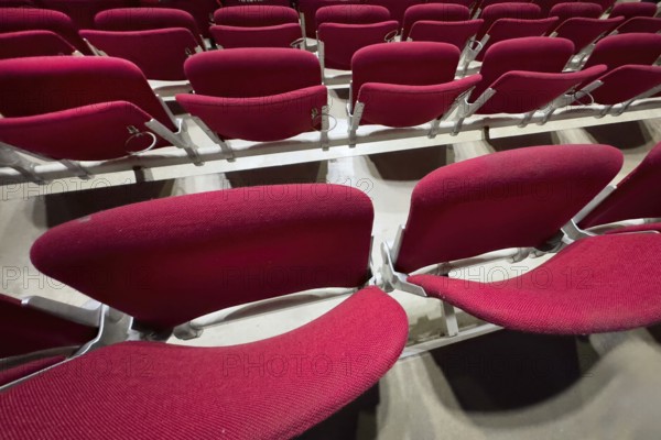 Empty folded-up seats Folding chairs with backrests in rows of seats mounted next to each other