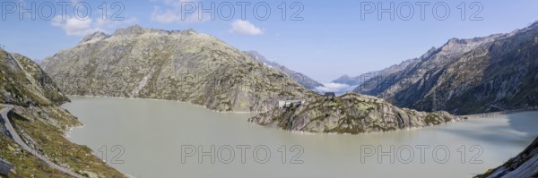 Grimselsee or Lake Grimsel with the historical Hotel Grimsel Hospiz near the Grimsel Pass in the