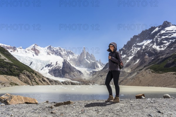 Young woman in front of Mount Cerro Torre, Laguna Torre Trail, El Chaltén, Santa Cruz Province,