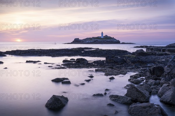 Godrevy Lighthouse, the lighthouse of Godrevy on Godrevy Island. In the evening at sunset. Long