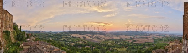 View from Montepulciano into a typical Tuscan landscape in Val d'Orcia with hills, trees, fields,