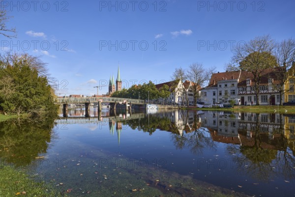 River Trave at high water, general architecture, pedestrian bridge, trees and bushes, reflections