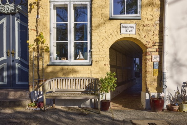 Historic building, Donats Gang, bench, flower pots with plants, street An der Obertrave, Old Town,